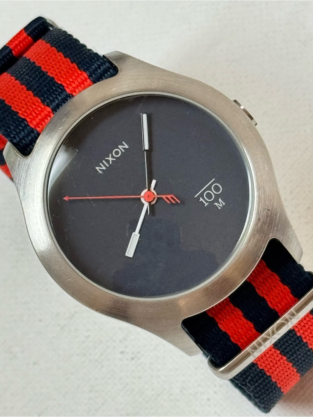 Nixon The Quad Men's Watch Silver Stainless Navy Blue Dial Red Striped Band A348